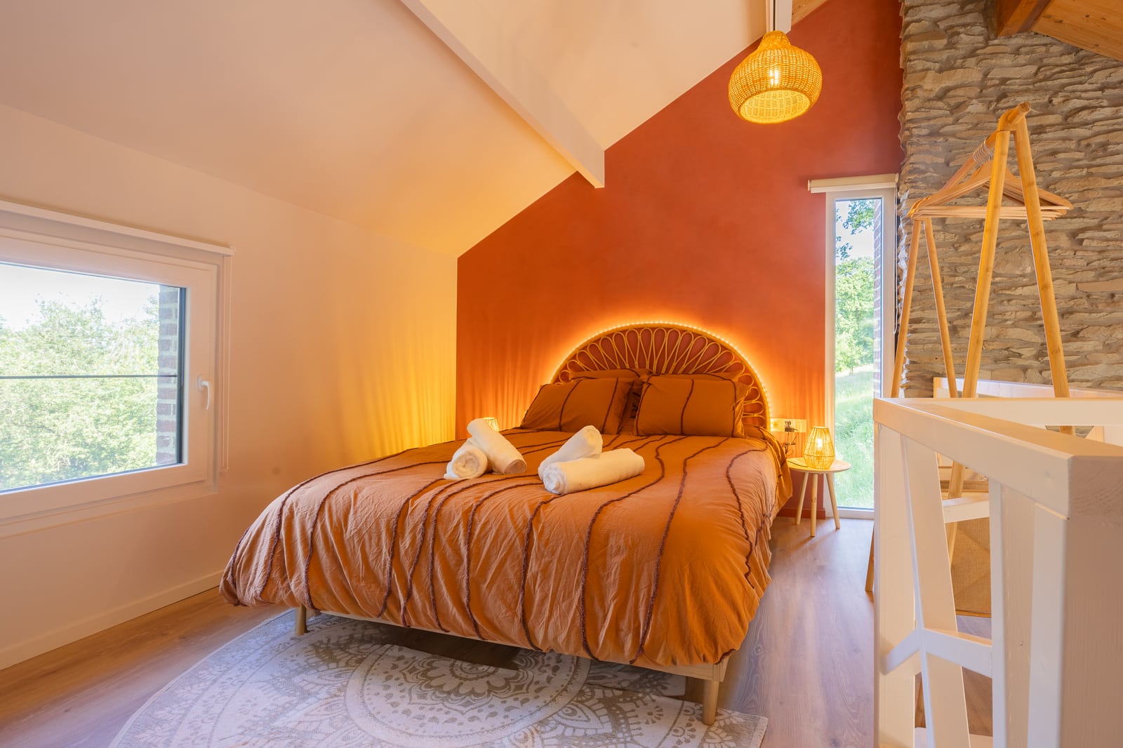 Warm bedroom with a queen-size bed and terracotta wall